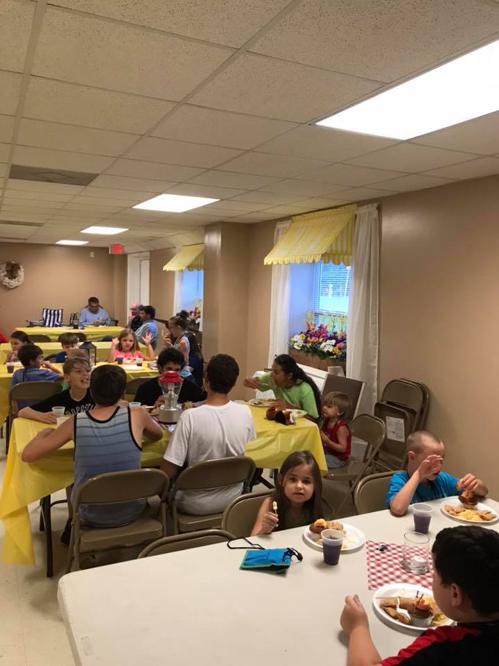 Children sharing a meal in the church fellowship hall